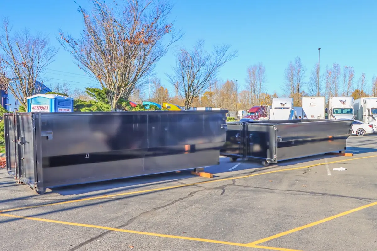 Professional dumpster rental service with roll-off container on residential driveway in Sugar Land